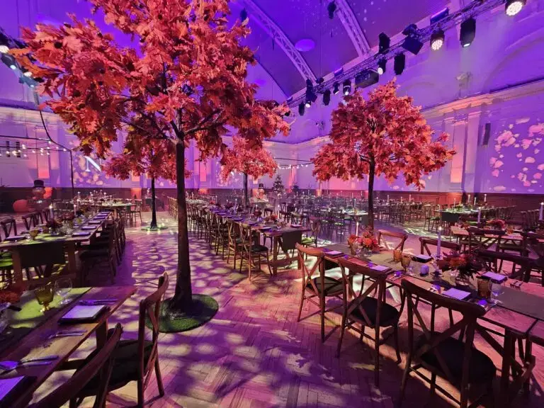 Corporate dinner with blossom trees and purple lighting