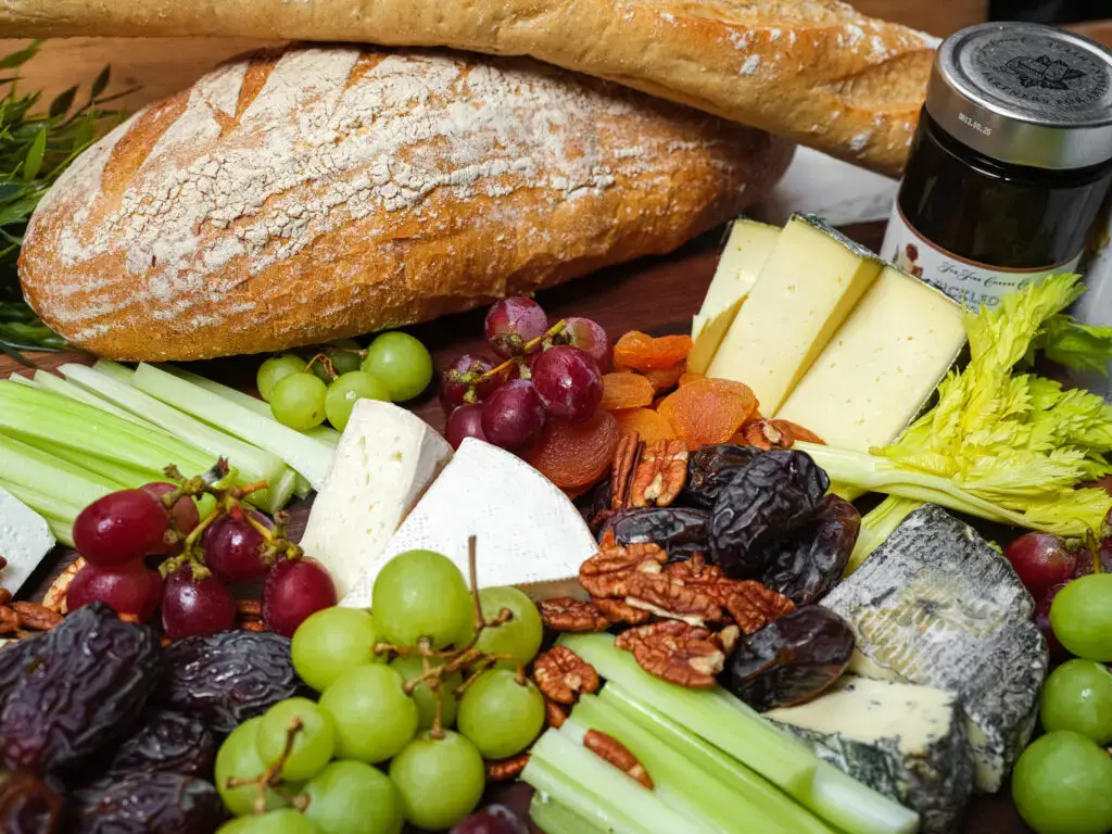 Cheese board with grapes and fresh bread